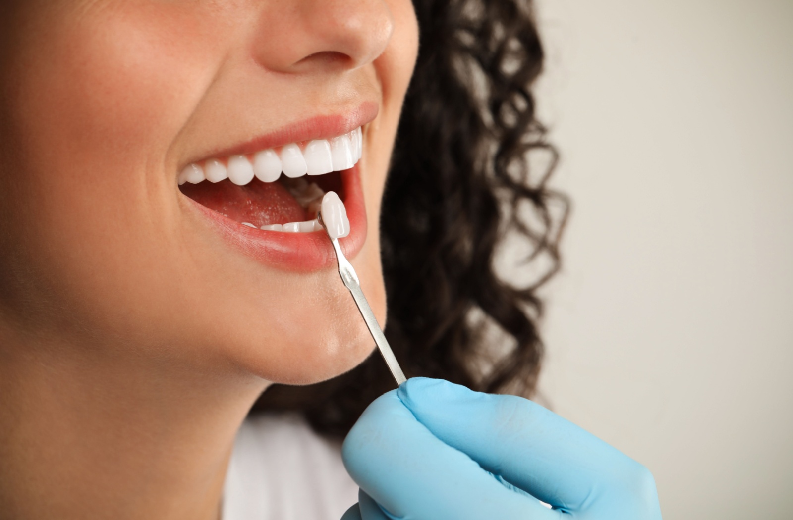 Happy patient smiling after receiving a dental crown.