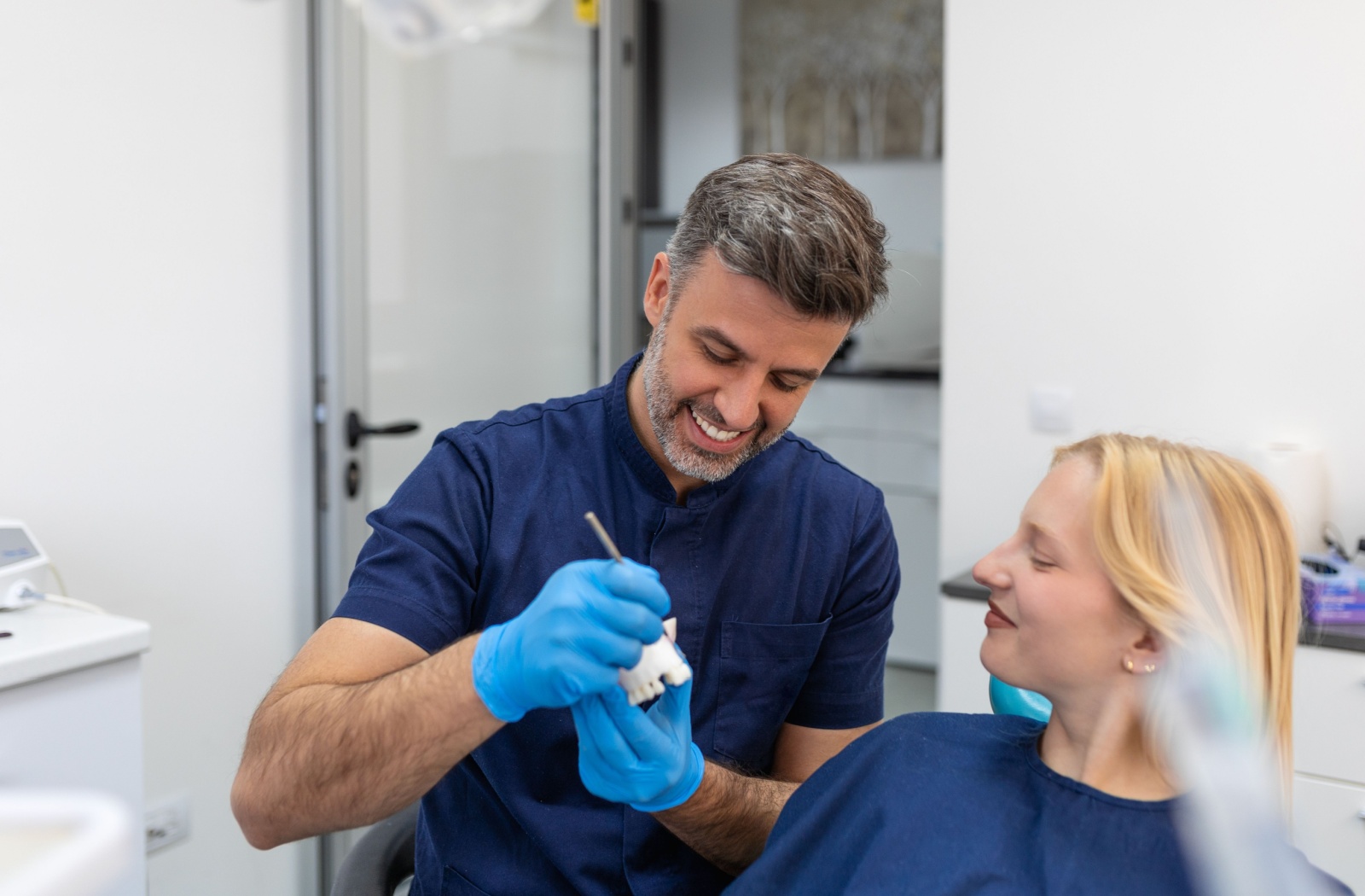 Dentist explaining dental crown aftercare to a patient.